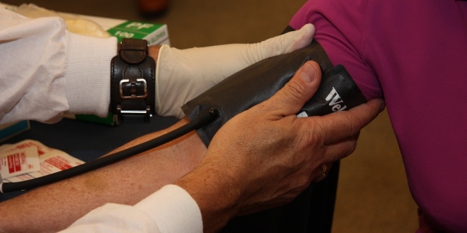 Resident gets blood pressure screening at Blood Pressure event.