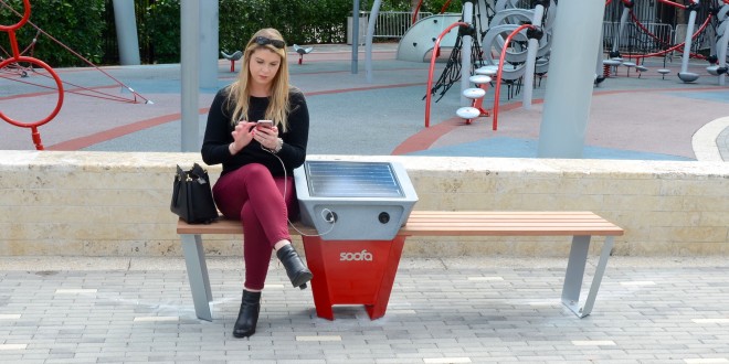 Photo of a woman using a soofa smart bench.