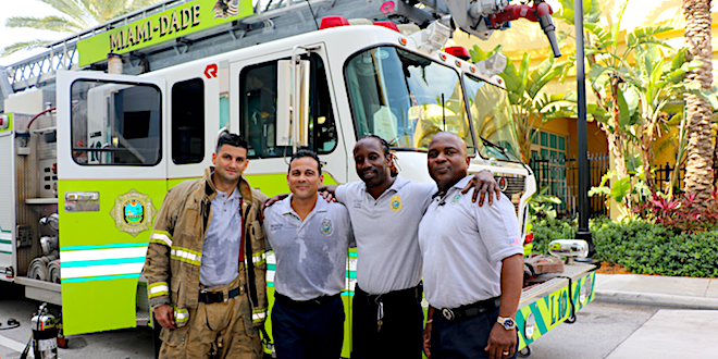 4 Miami Dade Fire Rescue Members Posting in front of their Miami Dade Fire Truck.