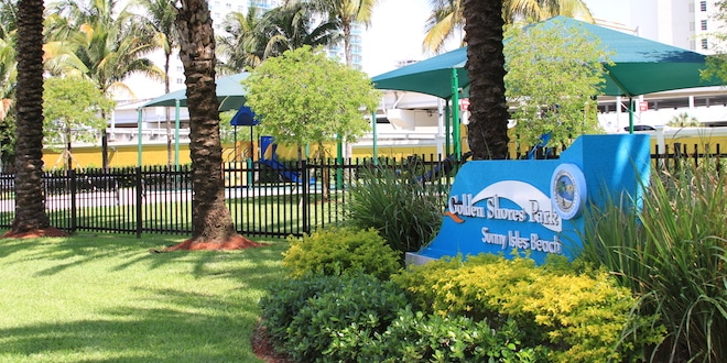 Photo: Golden Shores Community Park sign and playground equipment in the background