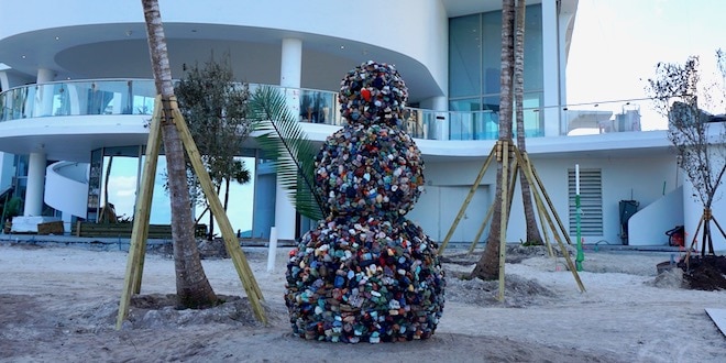 Snowman sculpture stands next to the Jade Signature building.