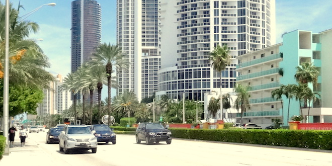 Cars driving on Collins Avenue through Sunny Isles Beach.