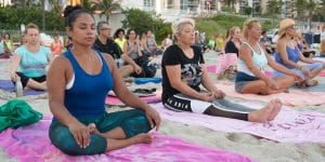 Full Moon Yoga class participants meditating on the beach