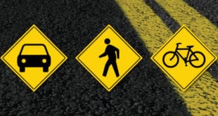 Road with street sign icons for a car, pedestrian and bicycle.