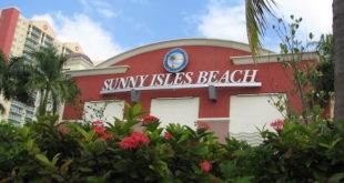 Red building with Sunny Isles Beach seal and lettering