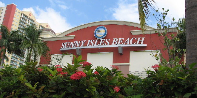 Red building with Sunny Isles Beach seal and lettering