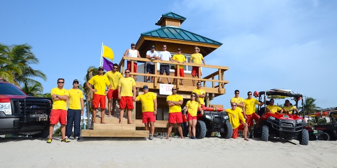 Sunny Isles Beach Ocean Rescue lifeguards posing for photo on lifeguard tower.