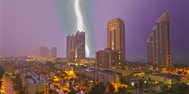 Large lightning strike hits the ocean at night close to Sunny Isles Beach.