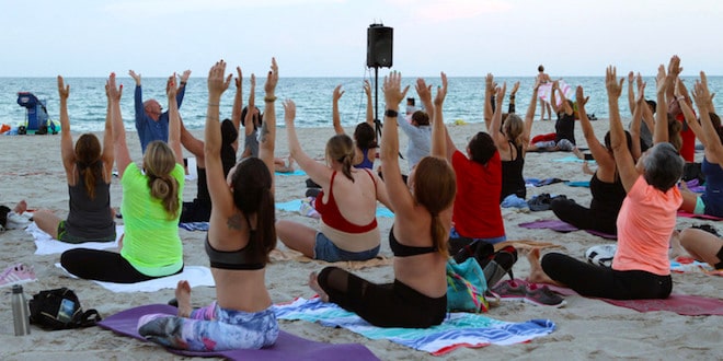 Class participants stretching during Full Moon Yoga on the Beach