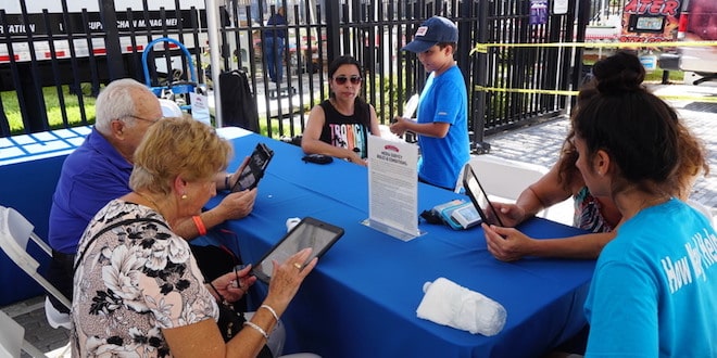 Residents participate in a media survey at the City's Anniversary Celebration