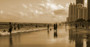 People on the beach in sepia tone photo