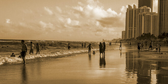 People on the beach in sepia tone photo