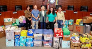 City Commission stands next to supply donations for Ukraine