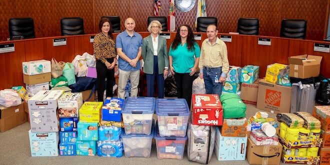 City Commission stands next to supply donations for Ukraine