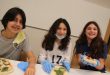 Three teens making pizza at a teens only cooking class