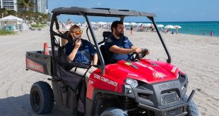 Two code enforcement officers monitoring the beach.