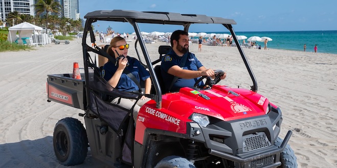 Two code enforcement officers monitoring the beach.